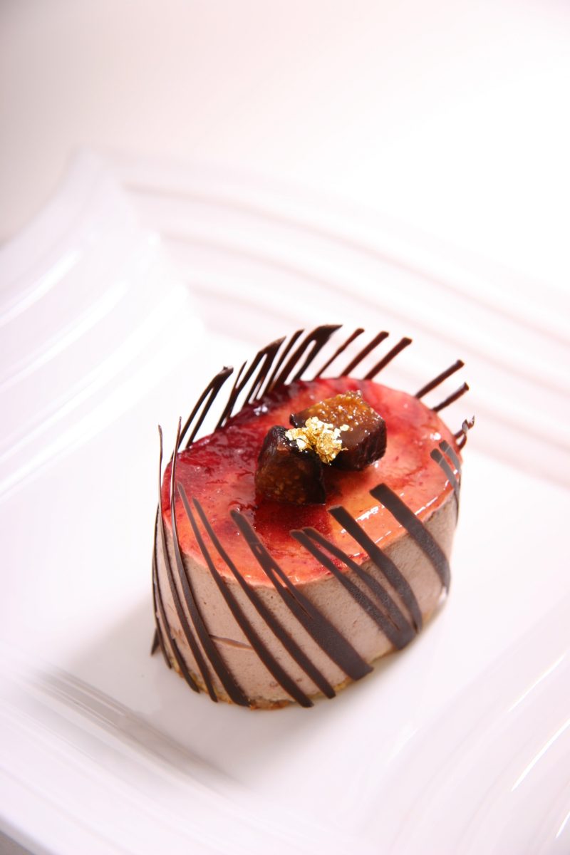 红色和褐色椭圆形巧克力糕点在陶瓷板上Red and Brown Oval Shape Chocolate Pastry on Ceramic Plate|巧克力,甜点,糖果,食品摄影,食物-海量高质量免版权图片素材-设计师素材-摄影图片-mitapix-美塔图像